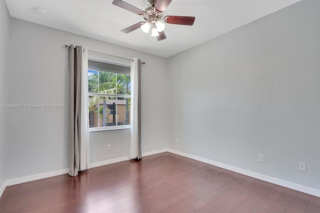 unfurnished room featuring ceiling fan and dark wood-type flooring