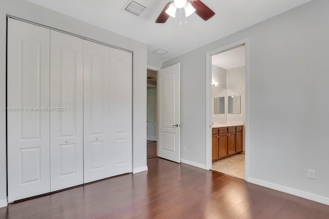 unfurnished bedroom featuring wood-type flooring, ceiling fan, ensuite bathroom, and a closet