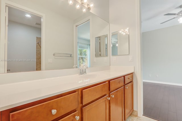 bathroom featuring ceiling fan, hardwood / wood-style flooring, and vanity