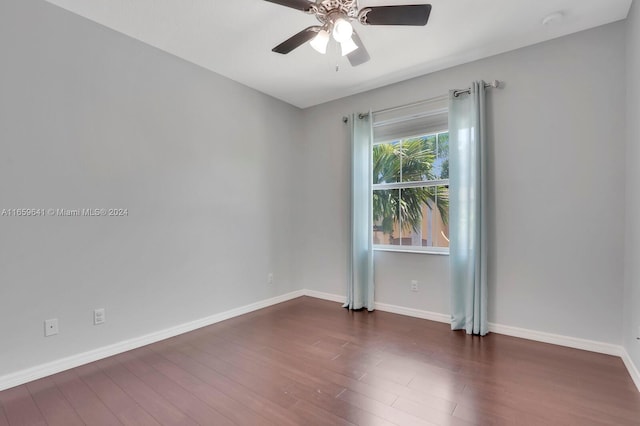 spare room featuring dark wood-type flooring and ceiling fan