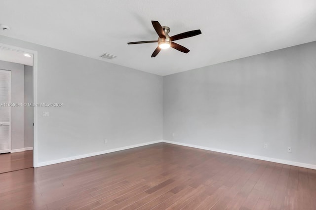 unfurnished room featuring ceiling fan and dark hardwood / wood-style floors