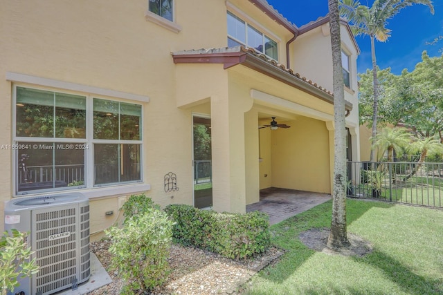 exterior space featuring cooling unit, a yard, ceiling fan, and a patio area