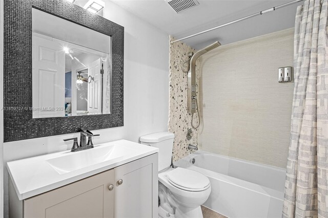 full bathroom featuring shower / bath combo with shower curtain, toilet, and vanity