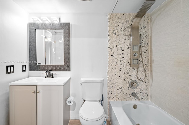 full bathroom with tiled shower / bath, vanity, and toilet