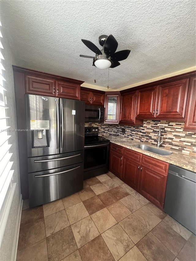 kitchen with ceiling fan, stainless steel appliances, sink, and tasteful backsplash