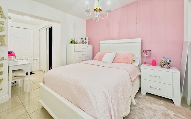 tiled bedroom featuring a chandelier