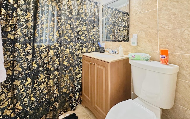 bathroom with tile walls, tile patterned floors, vanity, and toilet