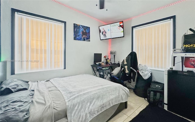 bedroom with ceiling fan and light tile patterned floors