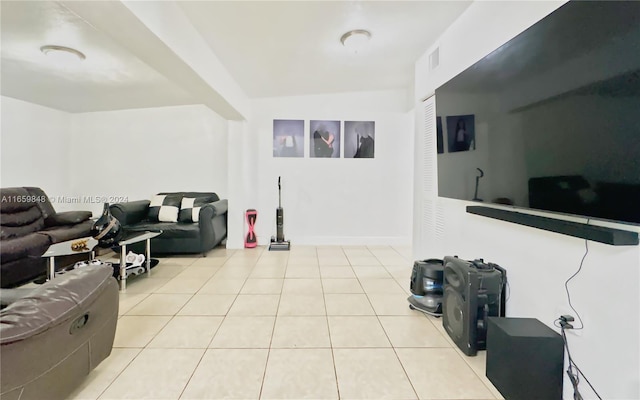 living room with vaulted ceiling and light tile patterned floors