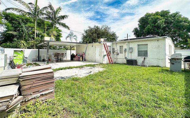 rear view of property featuring a patio area and a yard