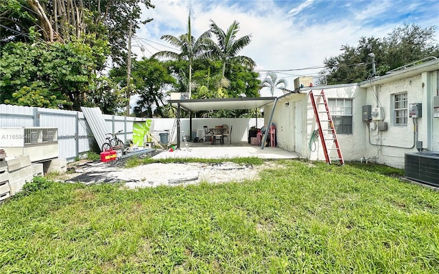 view of yard with central AC and a patio area