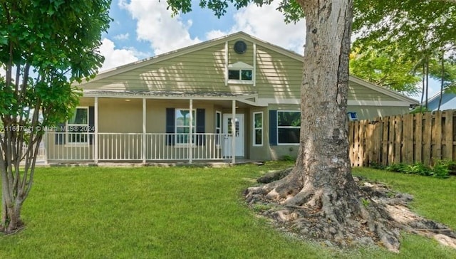 back of house featuring a yard and a porch