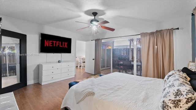 bedroom with ceiling fan, wood-type flooring, access to outside, and multiple windows