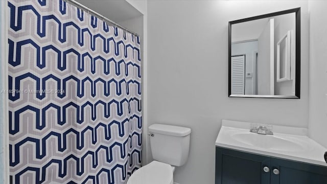 bathroom featuring vanity, a shower with shower curtain, and toilet