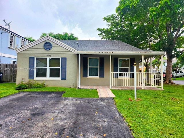 view of front of house with a front yard and a porch