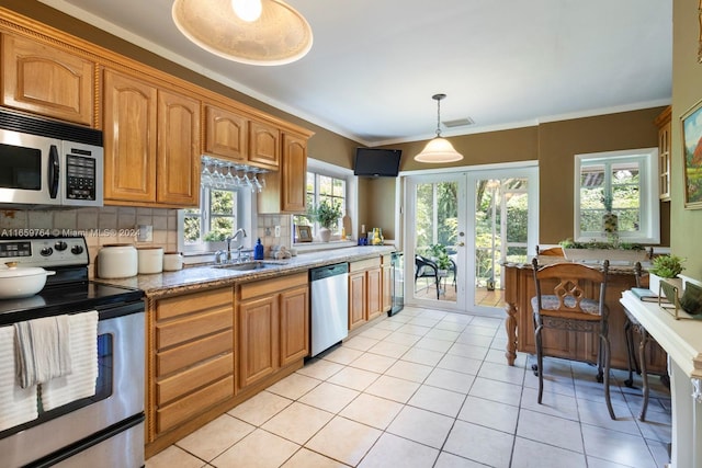 kitchen featuring light tile patterned floors, light stone counters, stainless steel appliances, sink, and tasteful backsplash