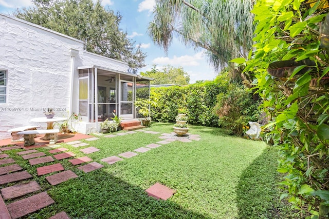 view of yard featuring a sunroom