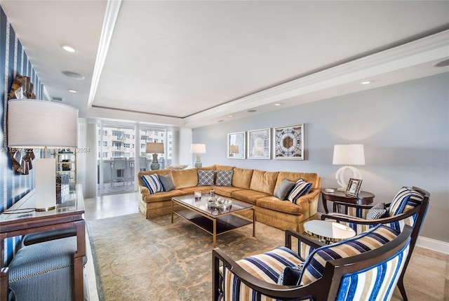 living room with a raised ceiling and ornamental molding