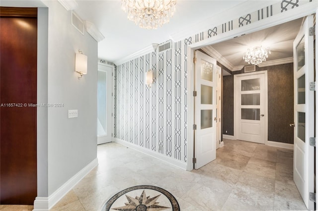 hall with ornamental molding and a notable chandelier