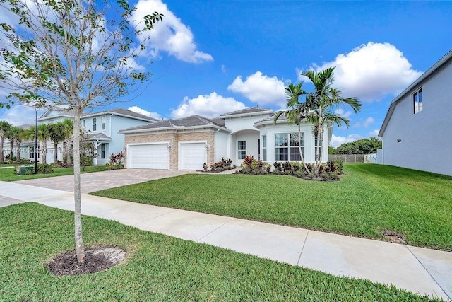 view of front facade with a front yard and a garage