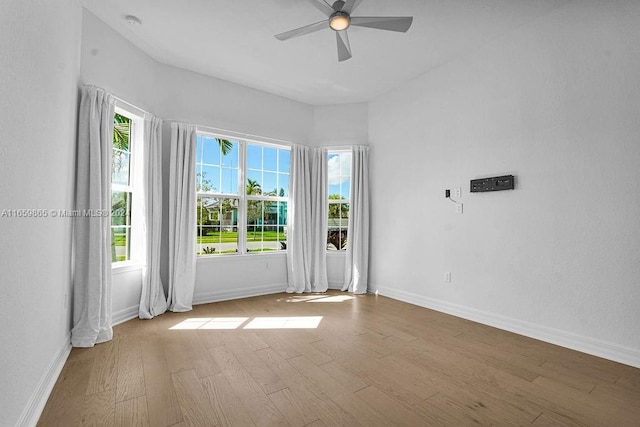 empty room featuring ceiling fan and light hardwood / wood-style flooring