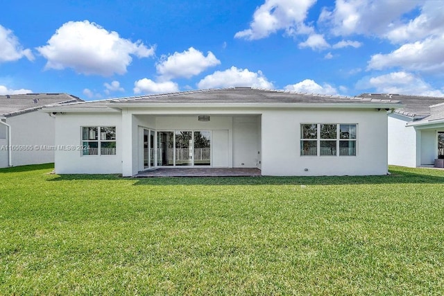 back of property featuring a yard and a patio area