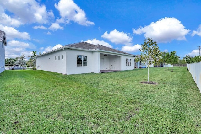 back of house with a lawn