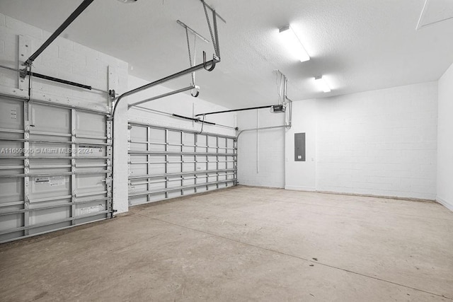 garage with electric panel and a garage door opener