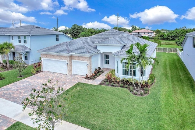 view of front of home featuring a garage and a front lawn