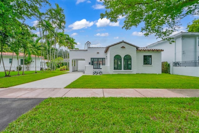 mediterranean / spanish home with a front yard