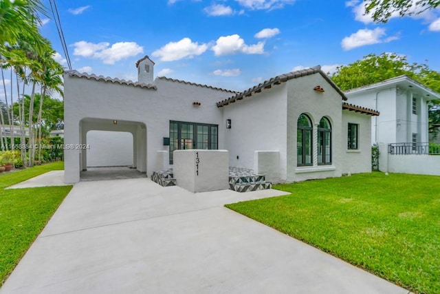 back of house featuring a lawn and a garage