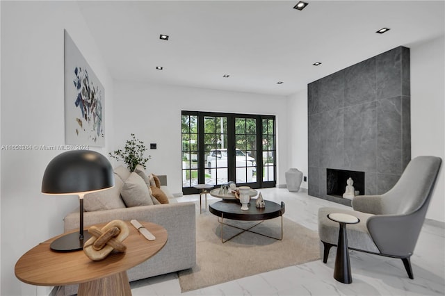 living room featuring a premium fireplace and french doors