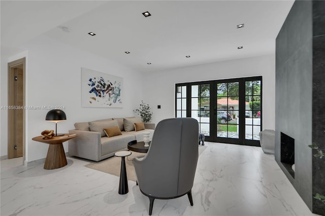 living room with a premium fireplace and french doors