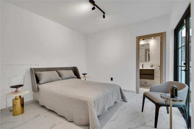 bedroom featuring connected bathroom and track lighting