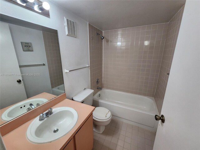 8240 SW 210th St Unit 302, Cutler Bay, FL 33189 - full bathroom with tile patterned floors, washtub / shower combination, toilet, and vanity