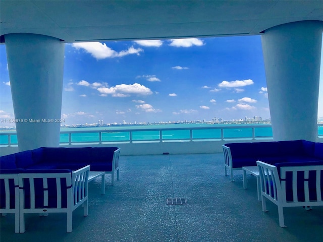 view of patio with an outdoor living space and a water view