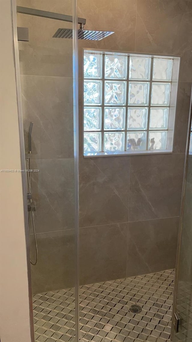 bathroom featuring a wealth of natural light and an enclosed shower