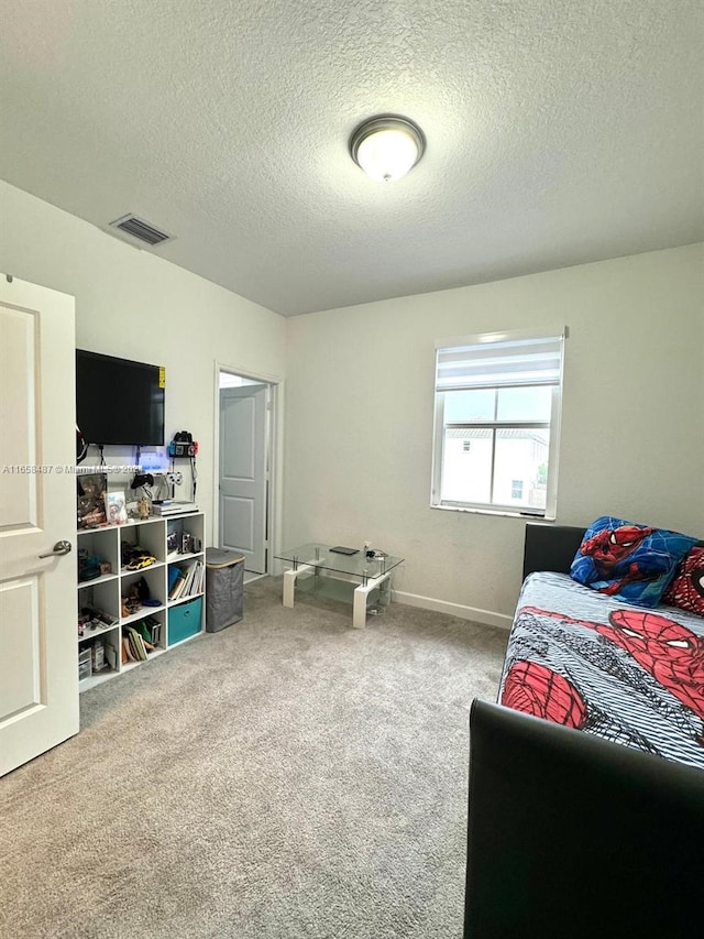 carpeted bedroom featuring a textured ceiling