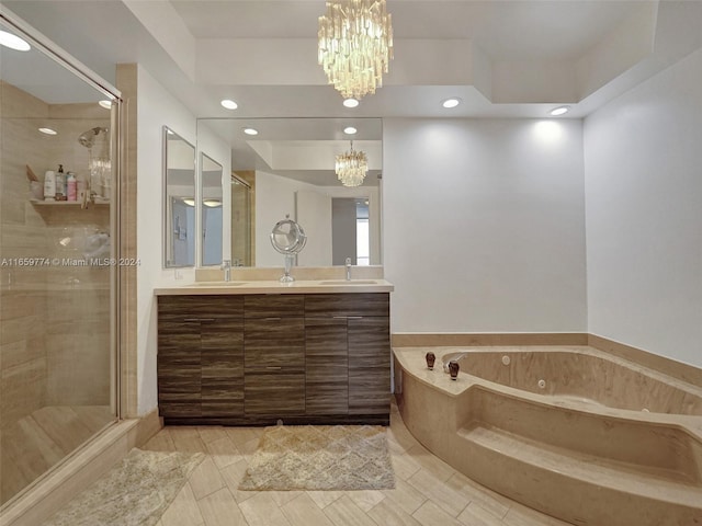 bathroom featuring vanity, separate shower and tub, and a notable chandelier