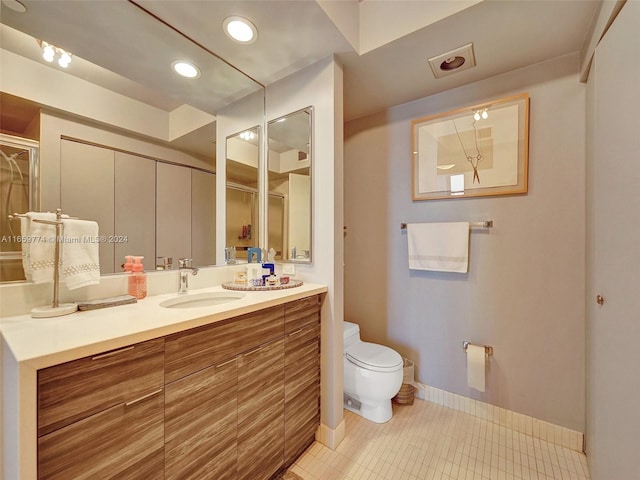 bathroom with vanity, toilet, and tile patterned floors