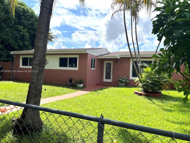 single story home featuring a front lawn