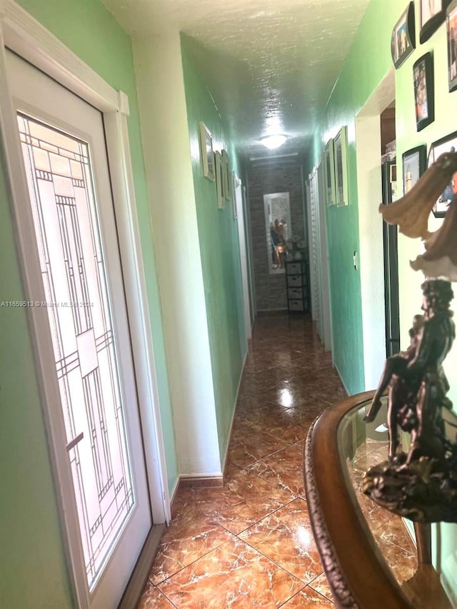 hallway with a textured ceiling