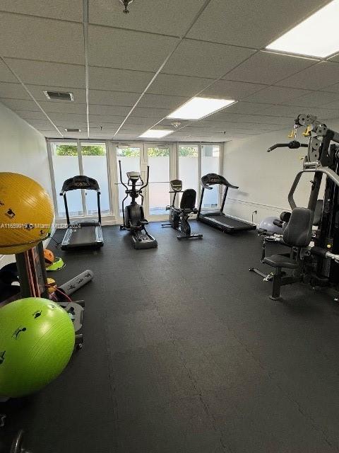 workout area featuring a paneled ceiling