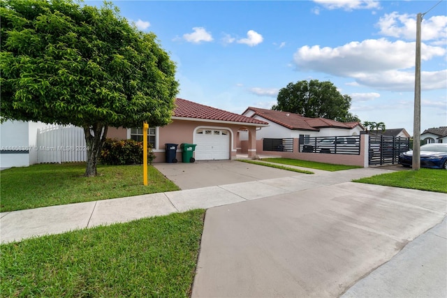 view of front of home with a garage and a front lawn