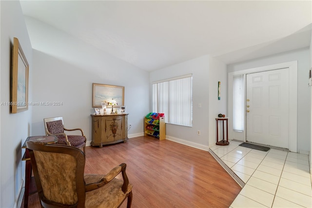 interior space with lofted ceiling and light hardwood / wood-style floors