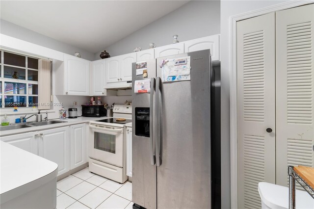 kitchen with lofted ceiling, white cabinetry, stainless steel fridge, and white electric range