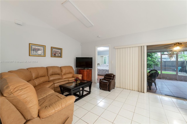 living room featuring lofted ceiling, ceiling fan, and light tile patterned floors