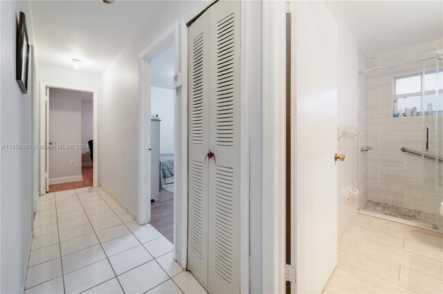 hall featuring light tile patterned floors