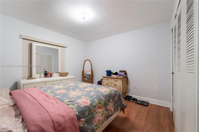 bedroom with hardwood / wood-style flooring