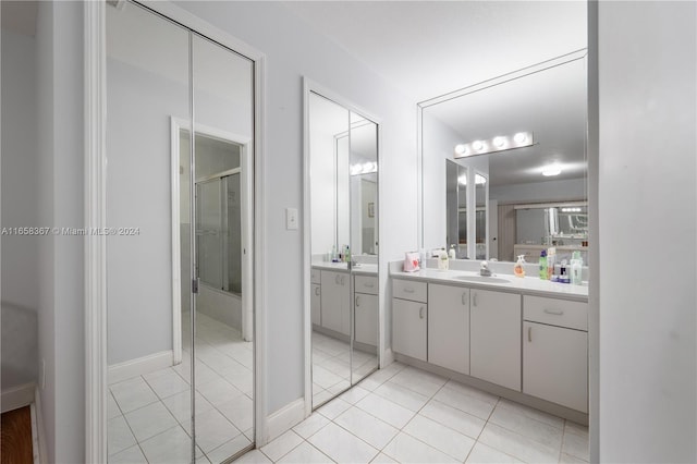 bathroom with tile patterned floors, vanity, and a shower with shower door